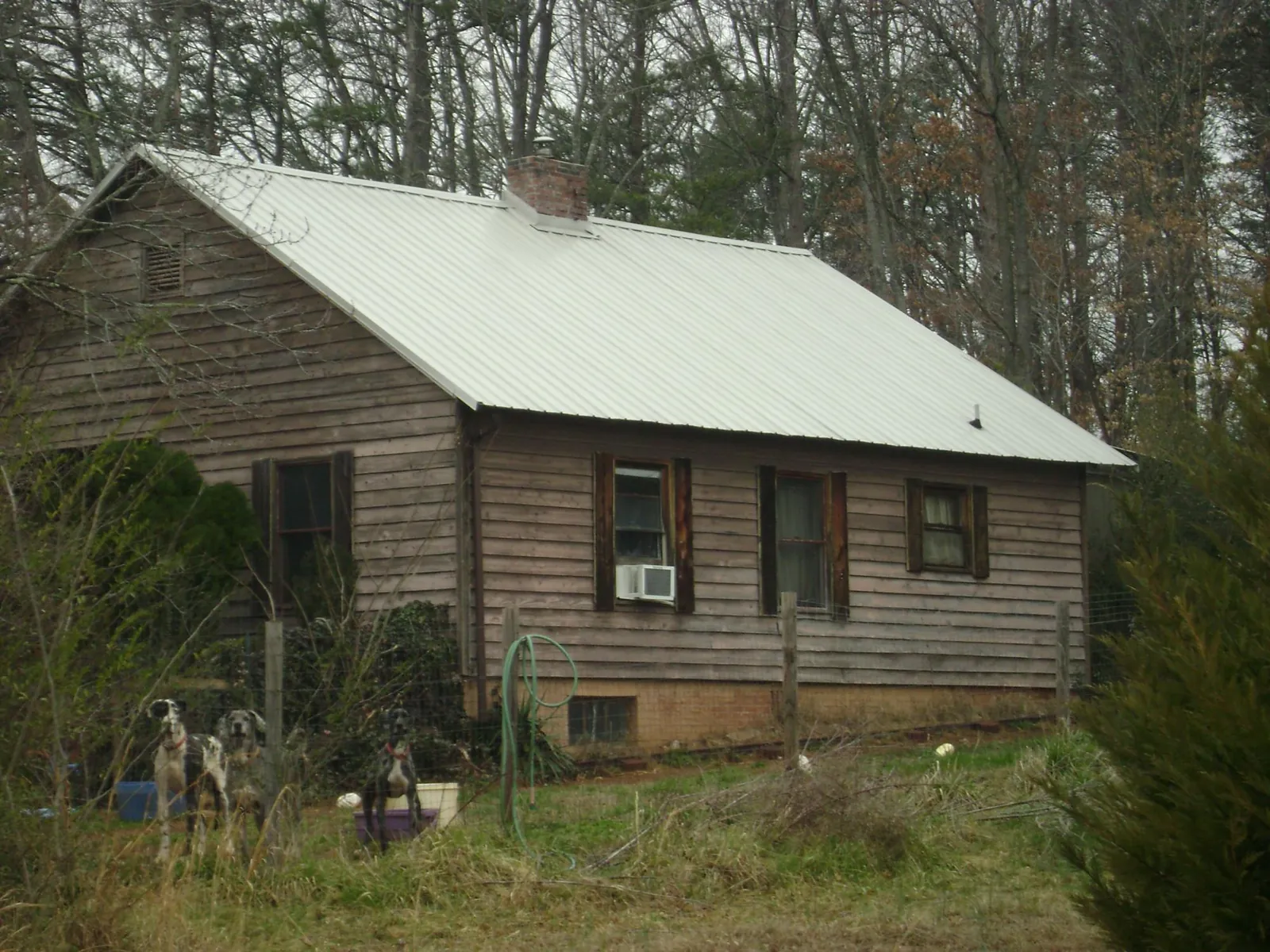 White metal roof on an old wood sided farmhouse, from a Metal Roof Installation job in North Walpole